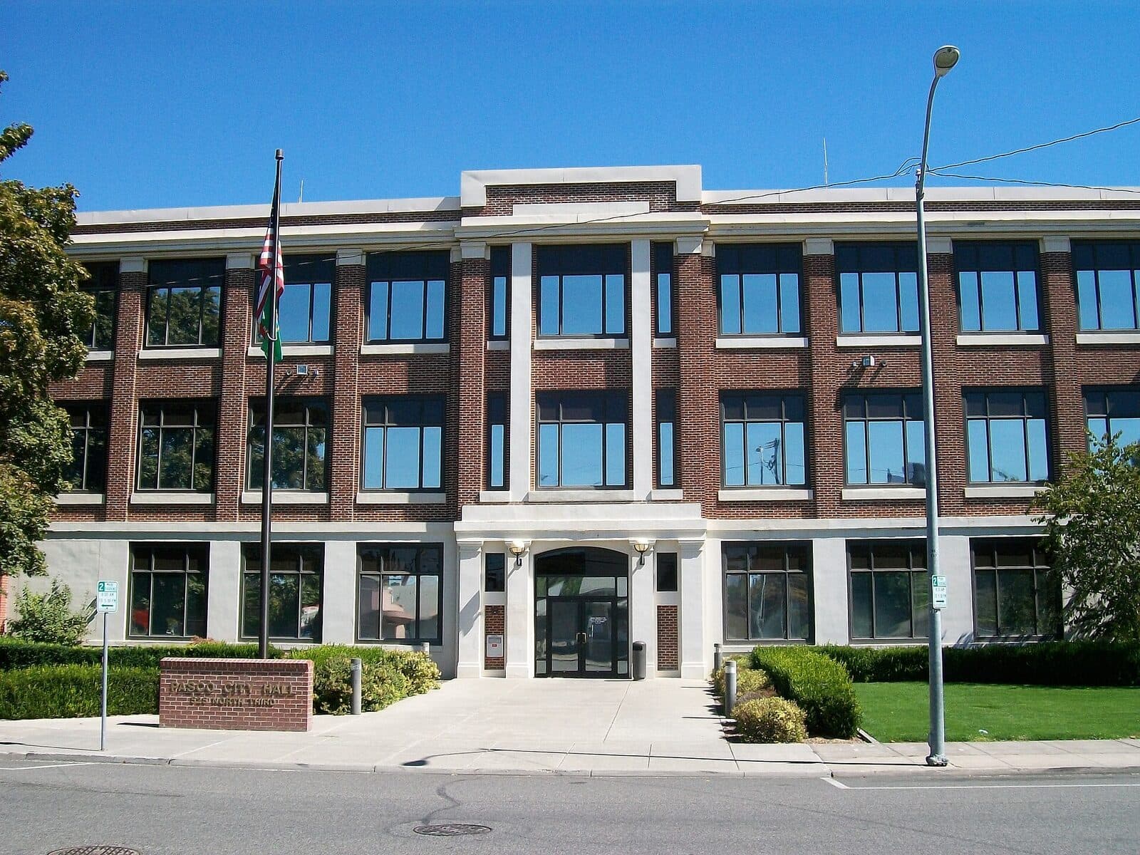 Vacant retail suites in a suburban commercial building with a parking lot in the foreground