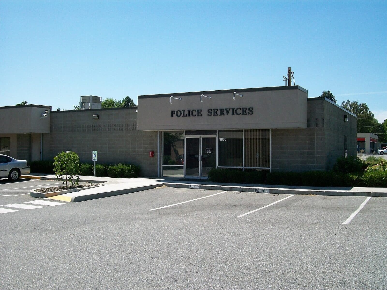 Exterior of a small-city police department building under a cloudy sky